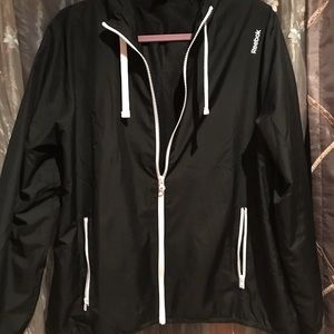 Reebok light windbreaker with lining and hood.